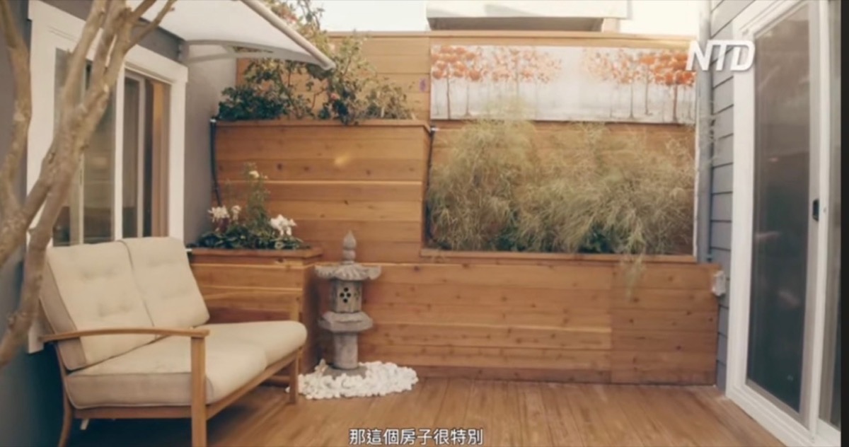 Zen-inspired courtyard with natural cedar decking, privacy wall, tiered planters and stone lantern