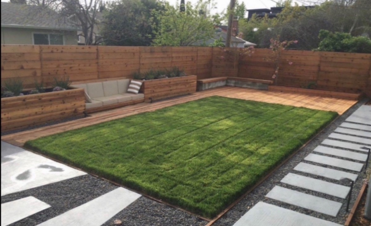 Complete garden maintenance: rectangular lawn area with cedar decking and concrete stepping stones
