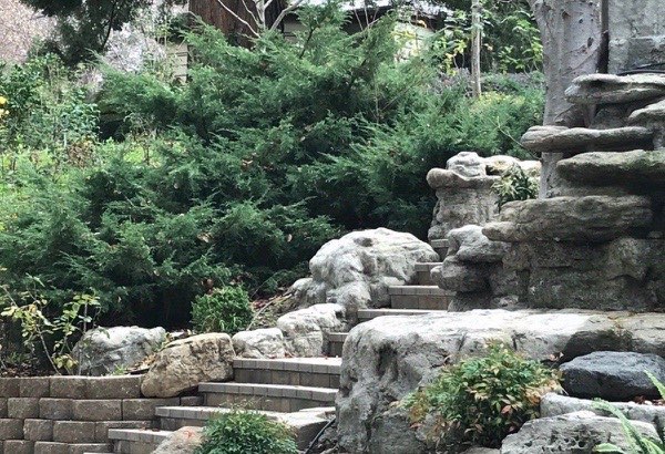 Naturalistic stacked boulder rock formation with built-in stone steps